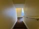 Stairway with wood steps and handrail leading to the upper level, providing easy access between floors at 3166 Riachuelo Ln, Kissimmee, FL 34744