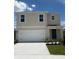 Charming two-story home featuring a two-car garage, neutral exterior, and well-manicured lawn at 3445 Briarwood Grove Dr, Ocoee, FL 34761