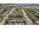 Aerial view of a community of townhomes with mature trees and ample parking at 3500 Calabria Ave, Davenport, FL 33897