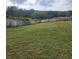 Wide shot of the backyard showing a beautiful green space with a wooded fence line at 3500 Calabria Ave, Davenport, FL 33897