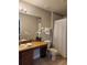 A cozy bathroom with a granite countertop, white towels and tiled floor at 3500 Calabria Ave, Davenport, FL 33897