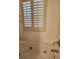 A tiled bathtub with jacuzzi jets and adjustable shutters above at 3500 Calabria Ave, Davenport, FL 33897