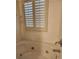 A tiled bathtub with jacuzzi jets and adjustable shutters above at 3500 Calabria Ave, Davenport, FL 33897