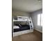 Bedroom features a white bunk bed with storage drawers and a window with plantation shutters at 3500 Calabria Ave, Davenport, FL 33897