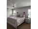 Spacious bedroom featuring a ceiling fan, plantation shutters, and elegant bedside lamps at 3500 Calabria Ave, Davenport, FL 33897