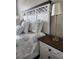 Bedroom showcasing a decorative headboard, patterned bedding, and a bedside lamp at 3500 Calabria Ave, Davenport, FL 33897