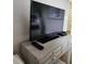 Bedroom featuring a flat screen TV, remote and modern console table with decorative drawer pulls at 3500 Calabria Ave, Davenport, FL 33897