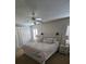 Bright bedroom with ceiling fan and shuttered windows, complemented by a decorative headboard at 3500 Calabria Ave, Davenport, FL 33897