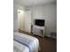 Bedroom featuring a white desk, TV and a door that leads to the walk in closet at 3500 Calabria Ave, Davenport, FL 33897