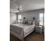 Spacious bedroom featuring a ceiling fan, plantation shutters, and elegant bedside lamps at 3500 Calabria Ave, Davenport, FL 33897