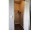 A small walk-in closet with wooden clothes hangers and a white rack at 3500 Calabria Ave, Davenport, FL 33897