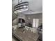 Bright dining area with a wooden table, stylish light fixture, and plantation shutters at 3500 Calabria Ave, Davenport, FL 33897