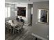 Open-concept dining area with a wooden table, seating, and view of the kitchen and living room creating a spacious layout at 3500 Calabria Ave, Davenport, FL 33897