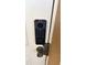 Close up of a modern doorbell with a keypad and camera on a painted door at 3500 Calabria Ave, Davenport, FL 33897