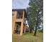 Townhome exterior featuring a private patio and balcony with lush landscaping at 3500 Calabria Ave, Davenport, FL 33897