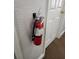 A standard fire extinguisher on a wall next to a doorway at 3500 Calabria Ave, Davenport, FL 33897