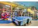 Colorful game room with air hockey table, fire truck, and play structure for Gathering fun at 3500 Calabria Ave, Davenport, FL 33897
