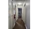 Hallway featuring neutral walls, carpeted floor and access to rooms at 3500 Calabria Ave, Davenport, FL 33897
