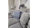 Close-up of a gray sofa with decorative pillows in a living room setting, highlighting comfort and stylish decor at 3500 Calabria Ave, Davenport, FL 33897