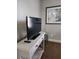 Living room setup features a flat screen TV on a wooden console table, perfect for relaxing after a long day at 3500 Calabria Ave, Davenport, FL 33897