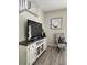 Living room featuring an entertainment center, decorative chair, and wood-look tile flooring at 3500 Calabria Ave, Davenport, FL 33897