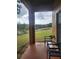 Patio with chairs that overlooks the green common area with trees and a fence at 3500 Calabria Ave, Davenport, FL 33897