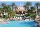 Resort-style pool surrounded by palm trees, lounge chairs, and lush landscaping at 3500 Calabria Ave, Davenport, FL 33897