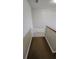 Neutral staircase leading to a second floor, fitted with a safety gate at 3500 Calabria Ave, Davenport, FL 33897