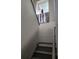 Bright stairway featuring a window, neutral colors and modern artwork enhancing the home's interior design at 3500 Calabria Ave, Davenport, FL 33897