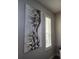 Close-up of a black and gold abstract art piece and white window shutters at 3500 Calabria Ave, Davenport, FL 33897