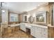 Luxurious bathroom featuring double vanities, soaking tub, and tile floors at 3520 N Westmoreland Dr, Orlando, FL 32804