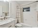Bright bathroom featuring a marble vanity, shower-tub combo, and great natural light at 3520 N Westmoreland Dr, Orlando, FL 32804