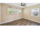 Comfortable bedroom featuring hardwood floors, natural light, and ceiling fan at 3520 N Westmoreland Dr, Orlando, FL 32804