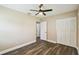 Neutral bedroom with hardwood floors, ample closet space, and a ceiling fan at 3520 N Westmoreland Dr, Orlando, FL 32804