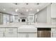 The updated kitchen has a farmhouse sink and breakfast bar open to living spaces at 3520 N Westmoreland Dr, Orlando, FL 32804