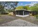 Exterior view of the home with brick patio, screened-in porch and vinyl siding at 3520 N Westmoreland Dr, Orlando, FL 32804