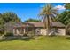 Expansive backyard with a screened enclosure, palm trees and lush landscaping creating a perfect outdoor retreat at 40137 County Road 452, Leesburg, FL 34788