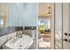 Well-lit powder room showcasing tile backsplash and direct access to screened outdoor patio at 40137 County Road 452, Leesburg, FL 34788