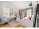 Bright bedroom featuring a work space, ample artwork and stylish décor at 40137 County Road 452, Leesburg, FL 34788