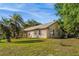 Exterior view of a well-maintained home featuring a screened enclosure and ample green space, blending comfort and nature at 40137 County Road 452, Leesburg, FL 34788