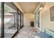Cozy screened-in front porch features brick flooring and a welcoming seating area at 40137 County Road 452, Leesburg, FL 34788