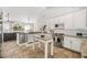 Bright kitchen with white cabinets, granite counters, and an eat-in island at 40137 County Road 452, Leesburg, FL 34788
