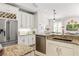Modern kitchen featuring granite countertops, stainless steel appliances, and white cabinetry at 40137 County Road 452, Leesburg, FL 34788