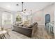 Inviting living space featuring tile floors, ceiling fans, shiplap accents, and ample natural light at 40137 County Road 452, Leesburg, FL 34788
