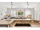 Open-concept living area with granite countertops, decorative ceiling fans, and a cozy sectional at 40137 County Road 452, Leesburg, FL 34788