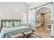 Luxurious primary bedroom with an ensuite bathroom featuring a sliding barn door entrance at 40137 County Road 452, Leesburg, FL 34788