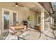 Spacious covered patio featuring an outdoor dining set and a built-in grill, perfect for entertaining at 40137 County Road 452, Leesburg, FL 34788