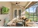 Inviting screened patio with comfortable seating, TV, and lush backyard views perfect for relaxation and outdoor entertainment at 40137 County Road 452, Leesburg, FL 34788