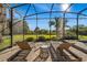 Relax on comfortable loungers by the pool, with a view of the private backyard within a screened enclosure at 40137 County Road 452, Leesburg, FL 34788