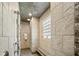 Modern tiled shower with glass block window and bench seating in the spa-like bathroom at 40137 County Road 452, Leesburg, FL 34788
